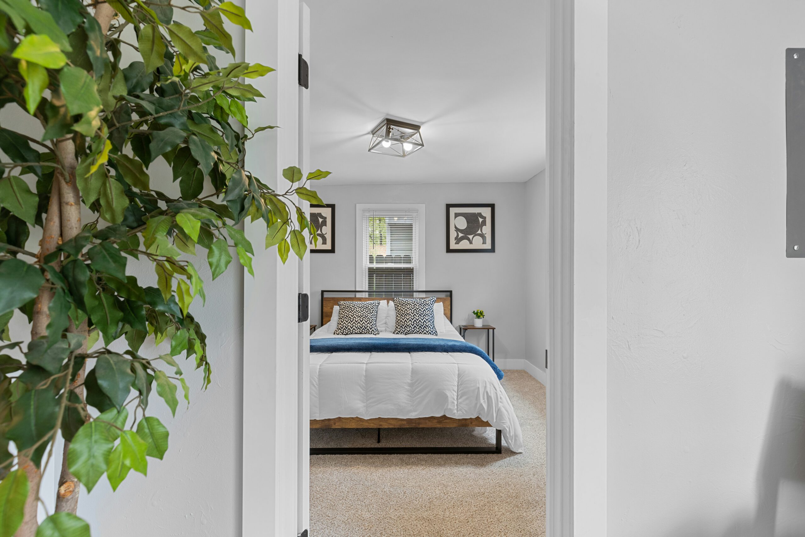 Professional cleaner preparing a spotless bedroom