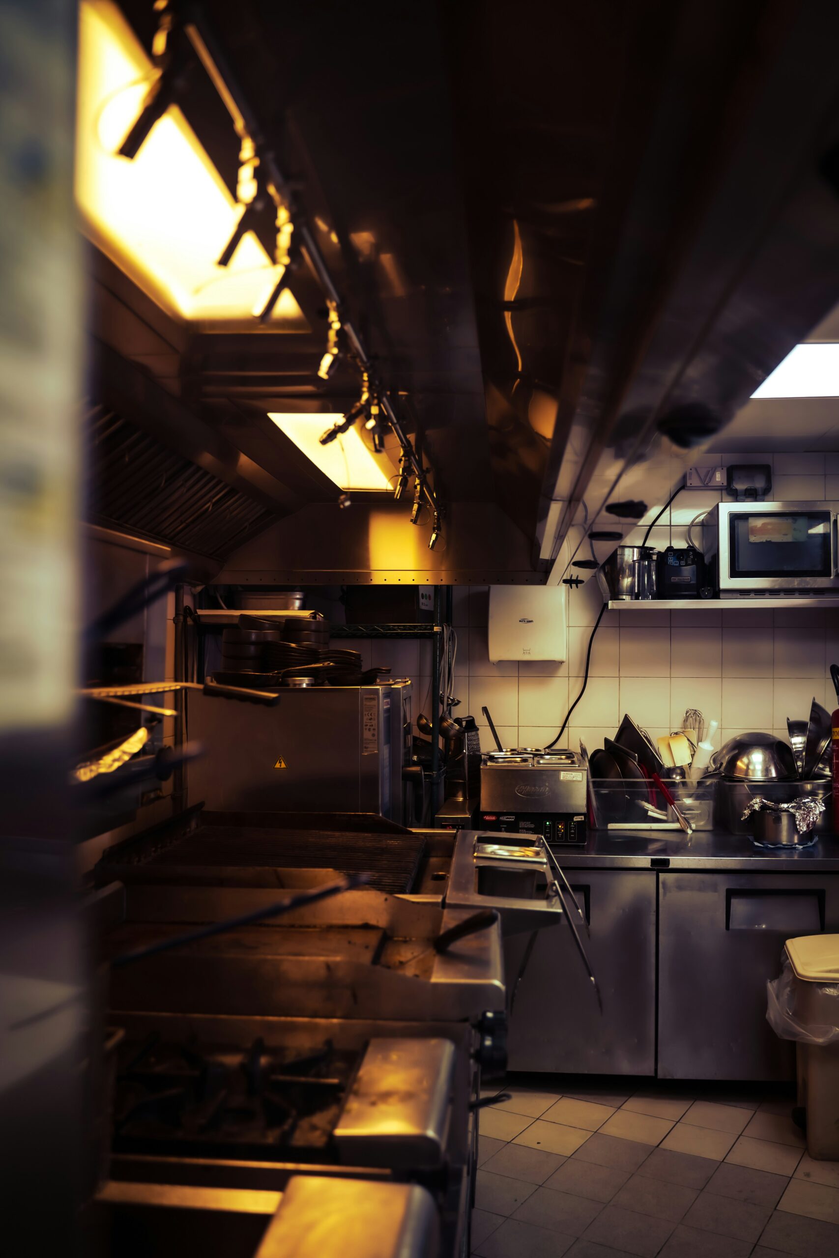 Clean commercial restaurant kitchen with stainless steel surfaces